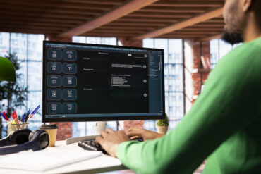 Man solving personal tasks with AI LLM chatbot answering prompts using predictive technology. Person using computer in apartment to interact with large language model program
