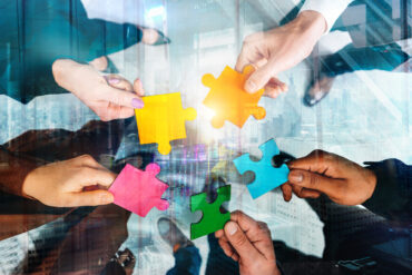 Business people connect puzzle pieces as integration and startup